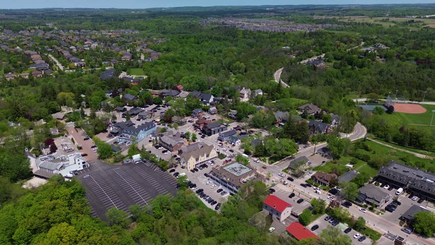 Drone view of Kleinburg village with residential neighborhoods roads commercial buildings and green landscape during a sunny spring day in Vaughan Ontario. Vaughan, Canada - May 26, 2026.