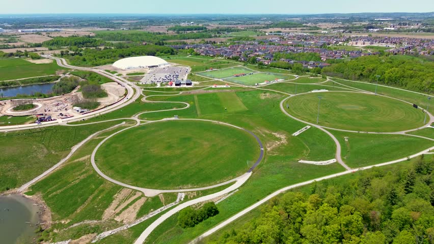 Drone aerial view of North Maple Regional Park in Vaughan Ontario featuring walking trails, green open space, soccer fields, sports facilities, and suburban neighborhoods surrounding the recreation area on a sunny day in Canada. Vaughan, Canada - May 26, 2026.