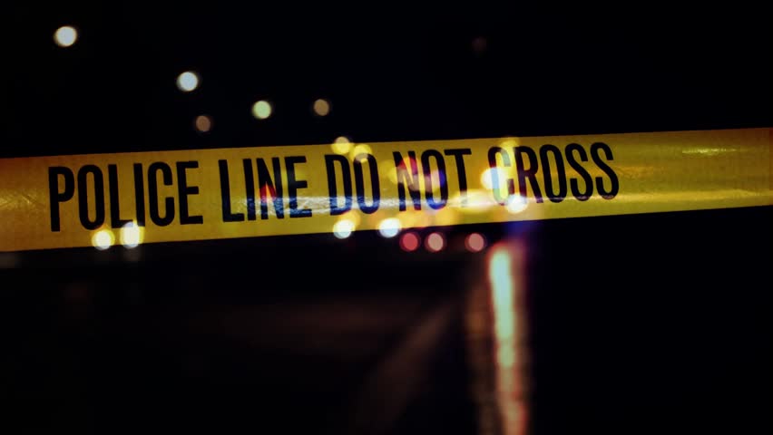 Stock 4K video clip footage of some Police Line tape with blue and red sirens.
