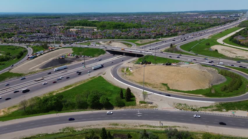 Aerial drone view of Vaughan Mills shopping centre, surrounding retail developments, parking lots, highways, residential towers, and the Greater Toronto Area skyline on a sunny spring day in Ontario Canada. Vaughan, Canada - May 26, 2026.