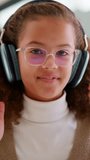 Girl, face and student with headphones for video call, online lesson or virtual class in home. Portrait, child or kid with wave, glasses or talking in POV for education, elearning or communication - Powered by Shutterstock - Get 15% off with code: PIKWIZARD15
