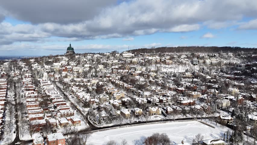 Saint Josephs Oratory dome above snowy Westmount and Montreal neighborhood on Mount Royal hill in winter, Quebec, Canada. g.