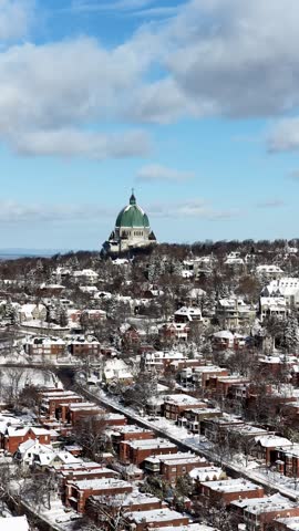 Saint Josephs Oratory dome above snowy Westmount and Montreal neighborhood on Mount Royal hill in winter, Quebec, Canada. g.