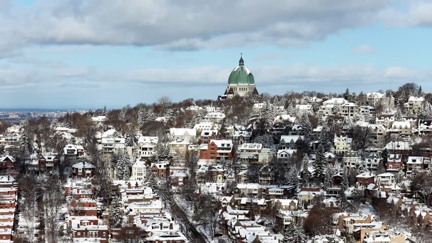 Saint Josephs Oratory dome above snowy Westmount and Montreal neighborhood on Mount Royal hill in winter, Quebec, Canada. g.
