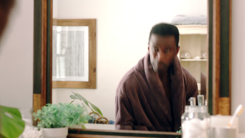Mirror, dancing and man with toothbrush for oral hygiene, wellness and grooming with smile in house. Bathroom, reflection and black person with dental care equipment, rhythm and celebration in home