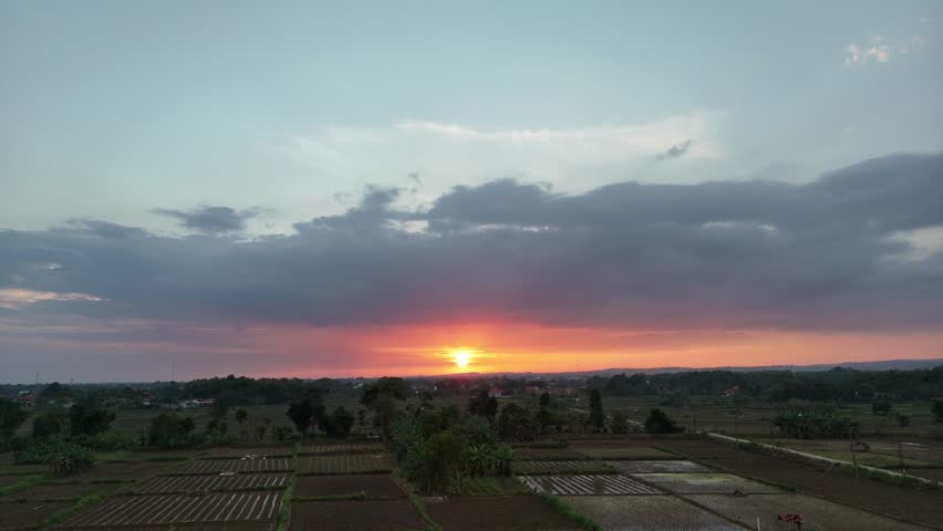 Beautiful Aerial View of Sunset Over Rural Rice Fields and Village