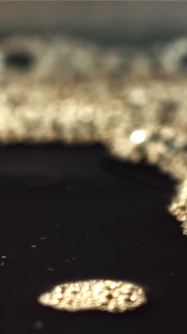 A stream of black coffee with splashes. Filmed on a high-speed camera at 1000 fps. High quality FullHD footage