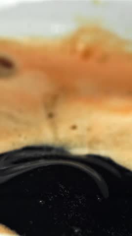 Falling drop in a cup of coffee. Filmed on a high-speed camera at 1000 fps. High quality FullHD footage
