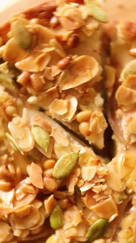 Top view of apple or pear pie, tart with caramel nuts on wooden table.