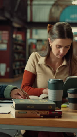 Library, tablet and woman with student group for writing notes, research and study at university. People, technology and internet connection for assignment, education and books at college facility