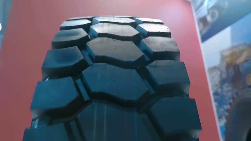 Large winter tread on a new truck wheel. Closeup. Shot in motion