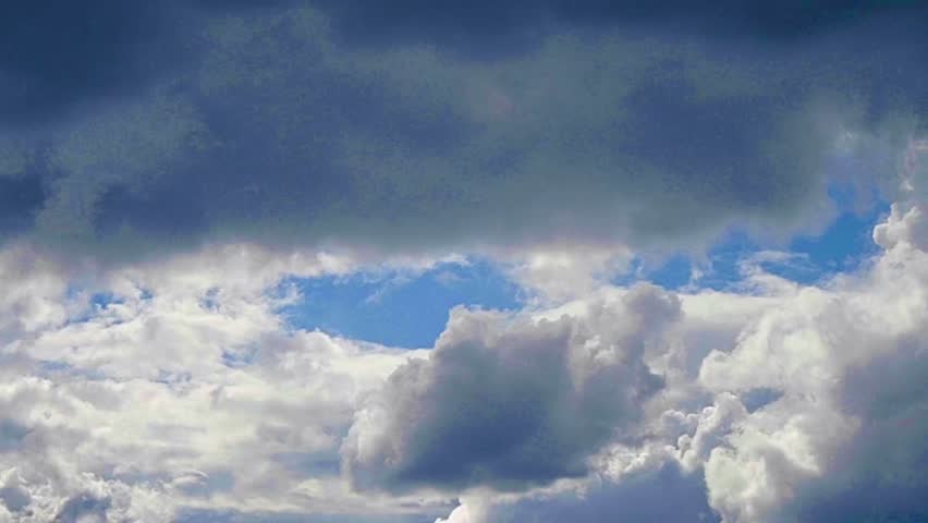 A dramatic, contrasting skyscape. The top of the image is dominated by thick, dark, bluish-gray clouds, hinting at impending bad weather or a storm.