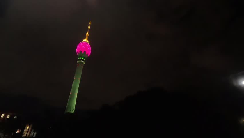 Lotus Tower Illuminated at Night Under Dark Cloudy Sky in Colombo Sri Lanka Cityscape View