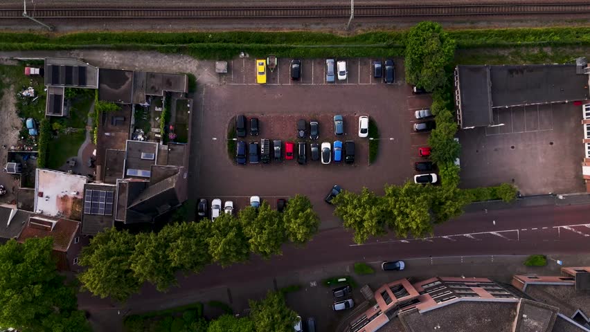 Aerial top down view of cars maneuvering in a parking lot
