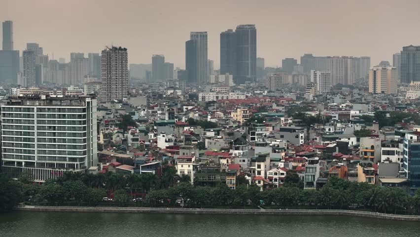 Aerial of Hanoi city, Vietnam. A busy road Traffic with plenty of Motorbikes. Concrete jungle in Cloudy day.