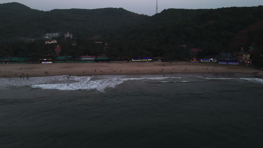 Aerial tracking shot of Gokarna Beach, evening dusk in Karnataka, India