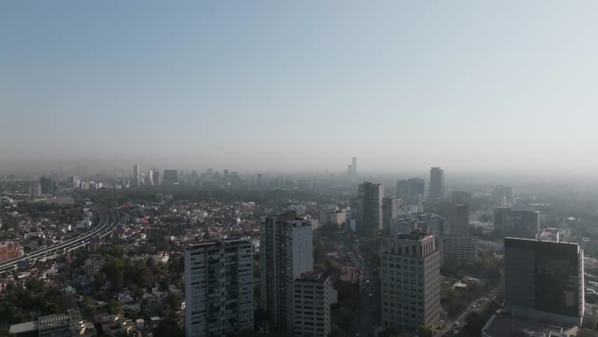 Aerial panoramic view of highway traffic on Periferico Sur and urban sprawl in southern Mexico City