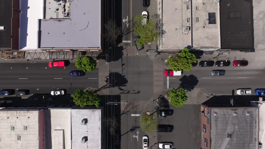 Top-down Aerial Of A Street Intersection With Railroad Tracks Crossing Through The Middle In Puyallup, Washington, United States.
