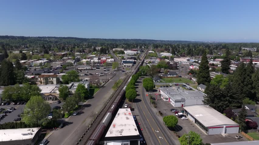 Traveling Train Through Downtown Puyallup, Washington, United States. Aerial Drone Shot