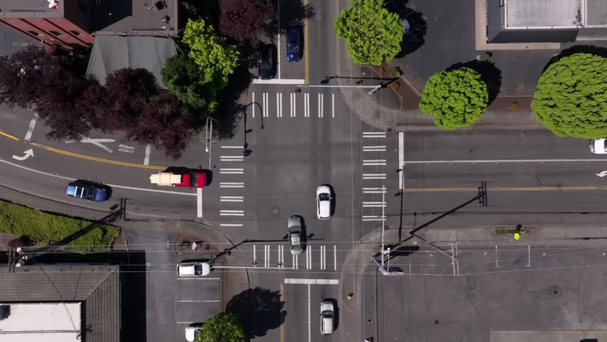Top-down View Of A Busy Urban Intersection With Marked Crosswalk In Downtown Puyallup, Washington, USA. Aerial Shot