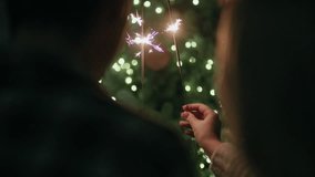 Couple celebrating with sparklers during holiday season at night. - Powered by Shutterstock - Get 15% off with code: PIKWIZARD15