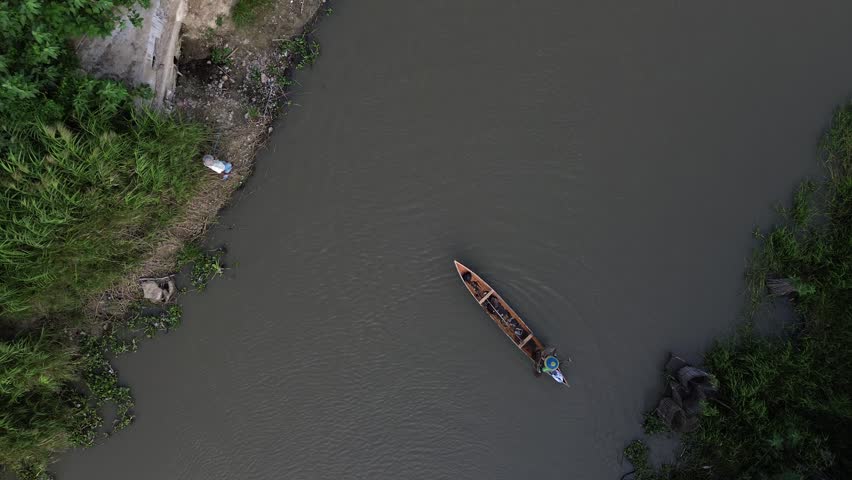 Aerial View of Fisherman Casting Net from Boat