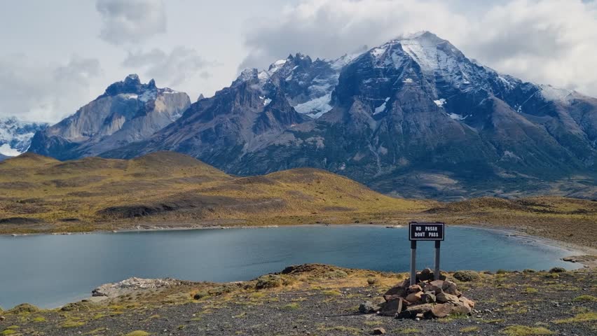 Scenic view of Lago Nordenskjöld and the rugged Cordillera del Paine in Torres del Paine National Park, Chile, beneath dramatic cloudy skies in remote Patagonian wilderness