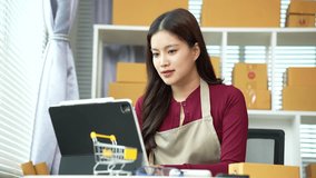 Smiling online entrepreneur packing customer orders while managing an e-commerce business from home, representing productivity, online sales, and small business success. - Powered by Shutterstock - Get 15% off with code: PIKWIZARD15