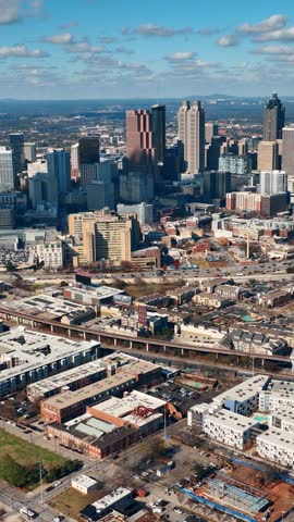 Aerial view footage of Atlanta Georgia. Tall skyscrapers in city center. Urban landscape with residential areas and highways.