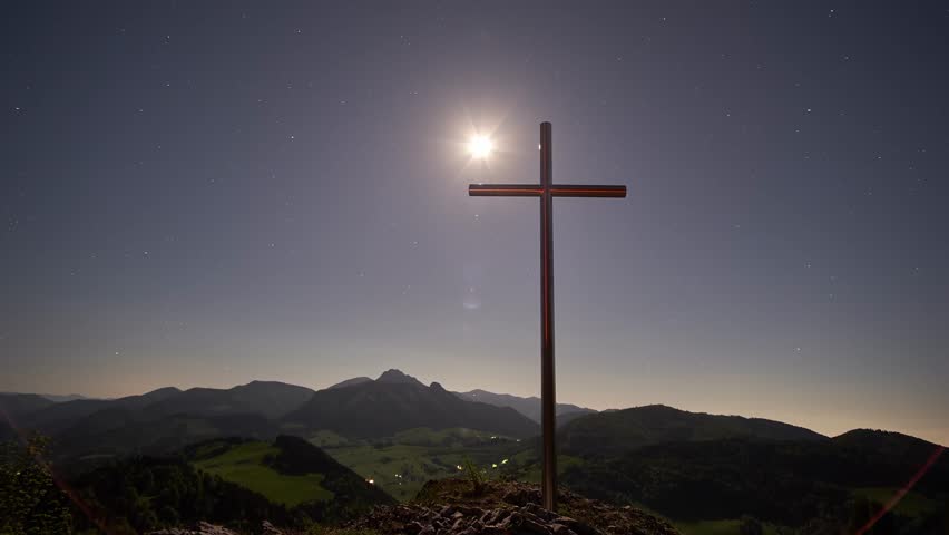Night Timelapse of Christian Cross on Mountain Summit Moonrise to Milky Way Over Mountain Landscape