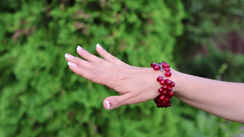A fashionable red garnet bracelet. A beautiful, graceful woman