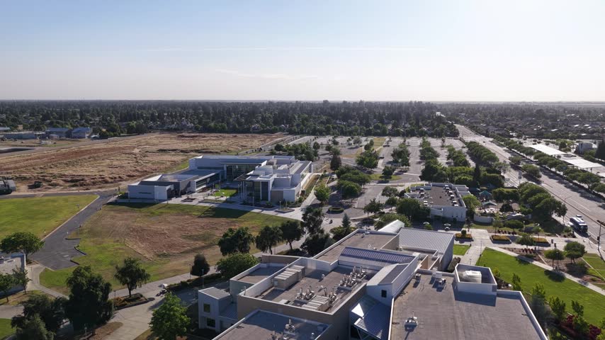 Drone perspective of the modern campus buildings and grounds of Clovis Community College in Fresno, California, showcasing its architecture and surrounding suburban landscape