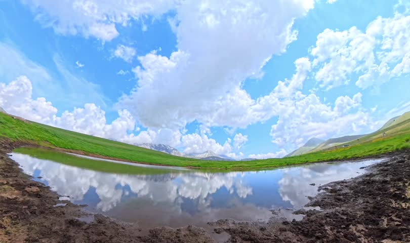 Time lapse of Campo Imperatore Racollo Lake mountain reflection in Gran Sasso Abruzzo in the spring season, Italy