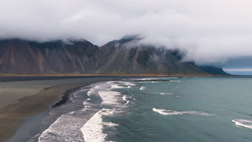 Vestrahorn coastal landscape with mossy rocks Vestrahorn. Hidden Icelandic shore with mist and volcanic formations