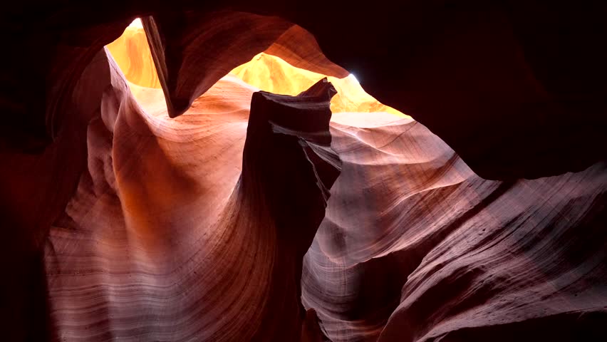 Beautiful sunlight illuminating the amazing textures and warm colors of the wave like sandstone formations inside the famous upper antelope canyon, a popular tourist destination in page, arizona