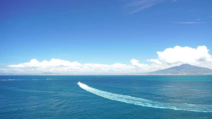 Blue Mediterranean sea view from boat moving in Naples Bay
