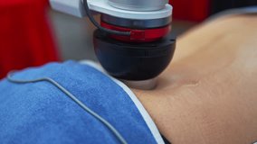 Man is getting a professional robotic massage for his back filmed in closeup. Combination of vibration and gentle electric stimulation to target muscle tissue. Powered by artificial intelligence - Powered by Shutterstock - Get 15% off with code: PIKWIZARD15