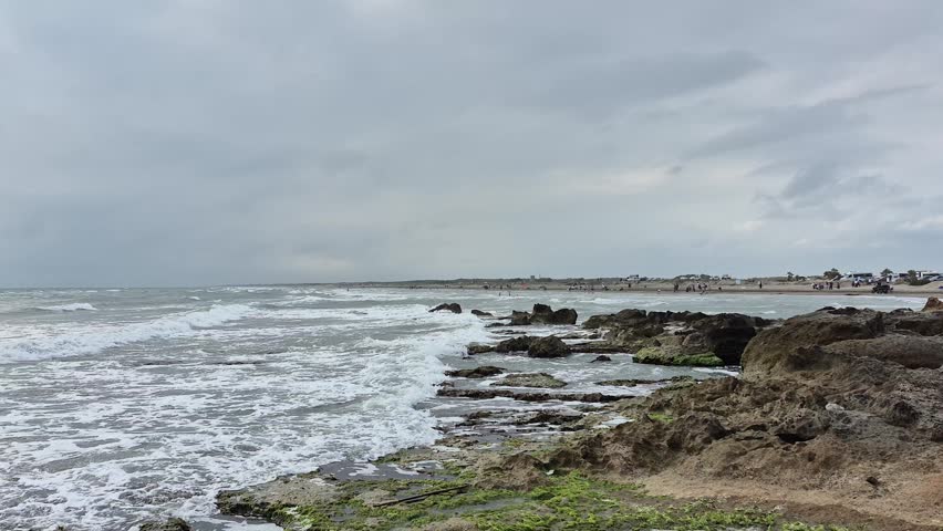 An overcast, windy sky and a choppy sea landscape