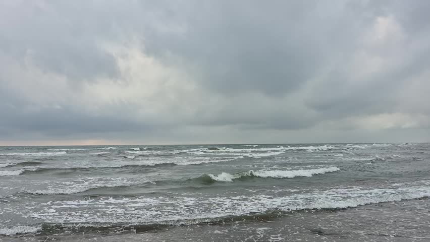 An overcast, windy sky and a choppy sea landscape