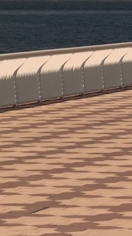 Seaside promenade with waterfront railing and paved walkway along ocean coast