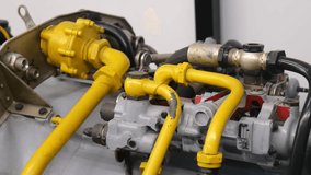 Close-up of yellow pipes, valves and metal components on a jet engine or aircraft fuel system, industrial aviation machinery detail with hoses, fittings and worn painted surfaces, no people - Powered by Shutterstock - Get 15% off with code: PIKWIZARD15