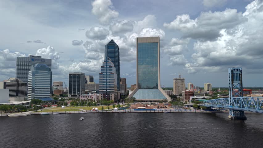 Aerial view of the Jacksonville skyline along the St. Johns River with the Main Street Bridge under a cloudy sky Jacksonville, Florida, United States.