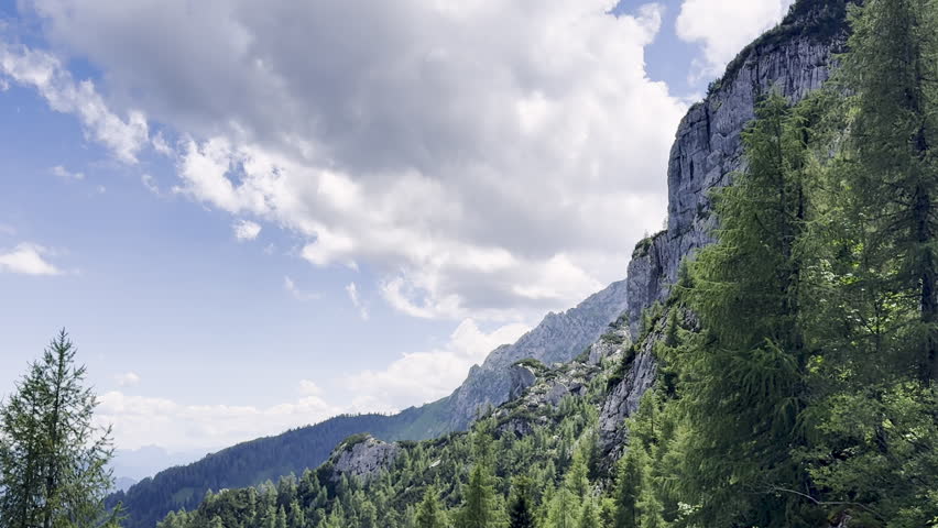 A granite precipice juts out in landscape shot of the Austrian Alps in Berchtesgaden. 