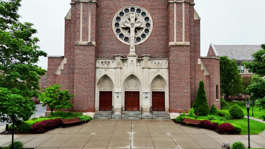 The front facade of a cathedral that practices the catholic religion.