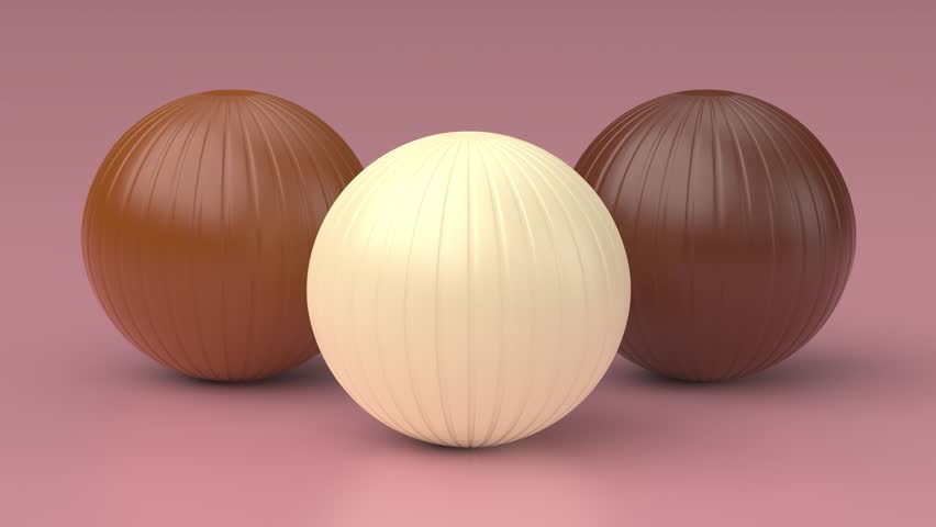 White, milk and dark chocolate balls on pink background