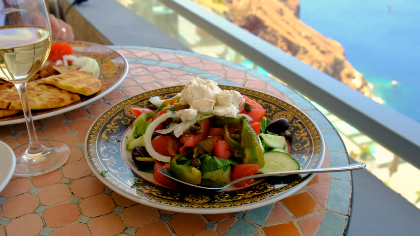 Greek salad and wine in Greece in a restaurant. Selective focus. Food.