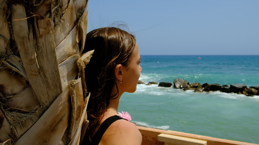 Woman looking at the sea. Selective focus. summer.