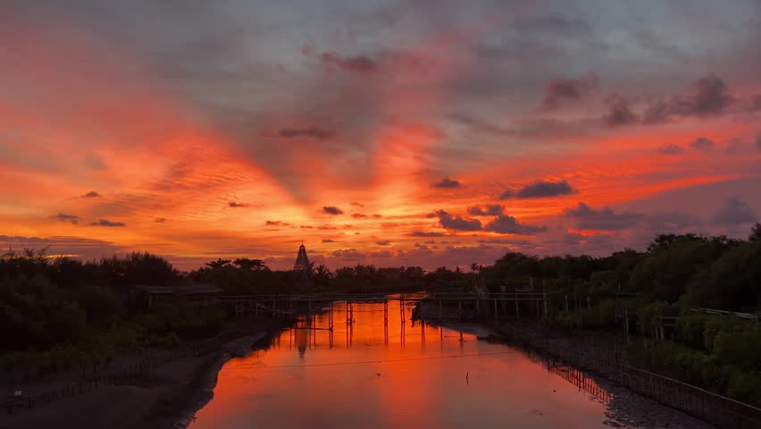 Sunset on mangrove river next to the beach