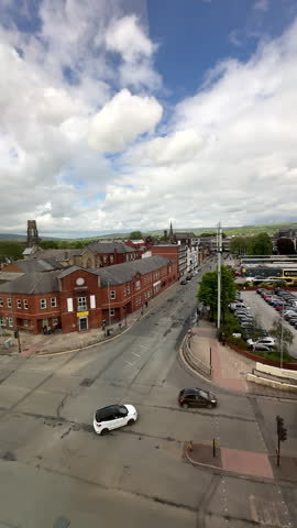 Vertical shot. Bury town in Northwest of England elevated view. Crossroads by bus interchange station, view through window.
