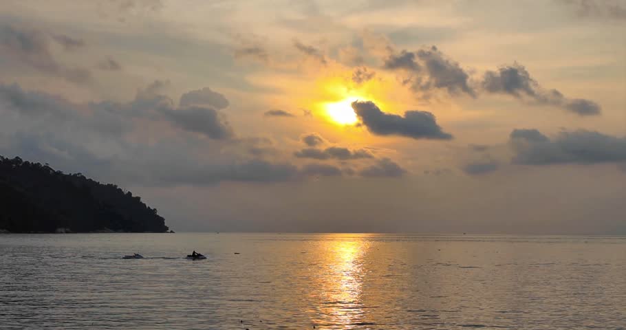 Boat in the sea at sunset with cloudy sky, Malaysia